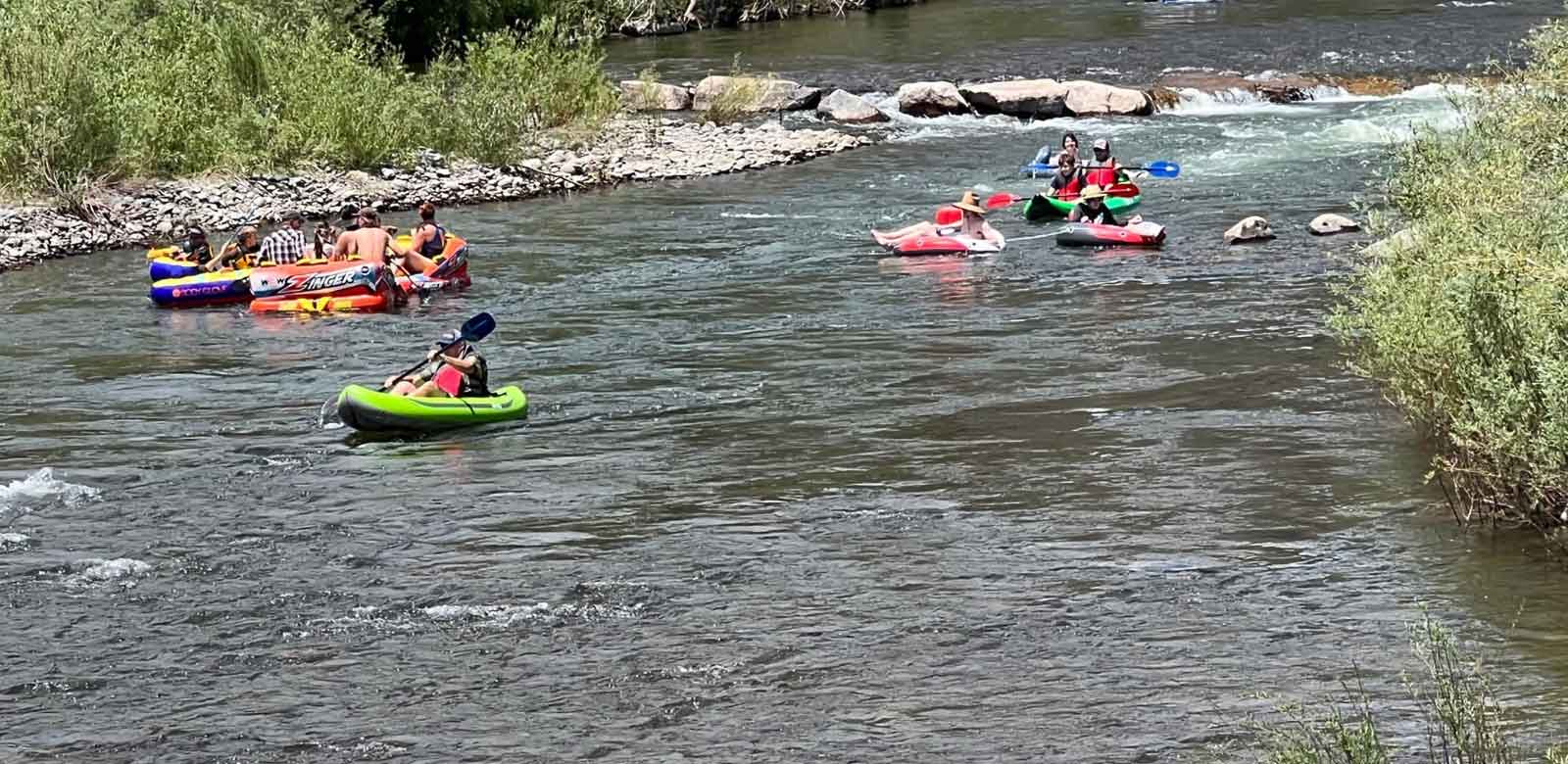 Tubers, kayaker and people enjoying the river outside our hotel