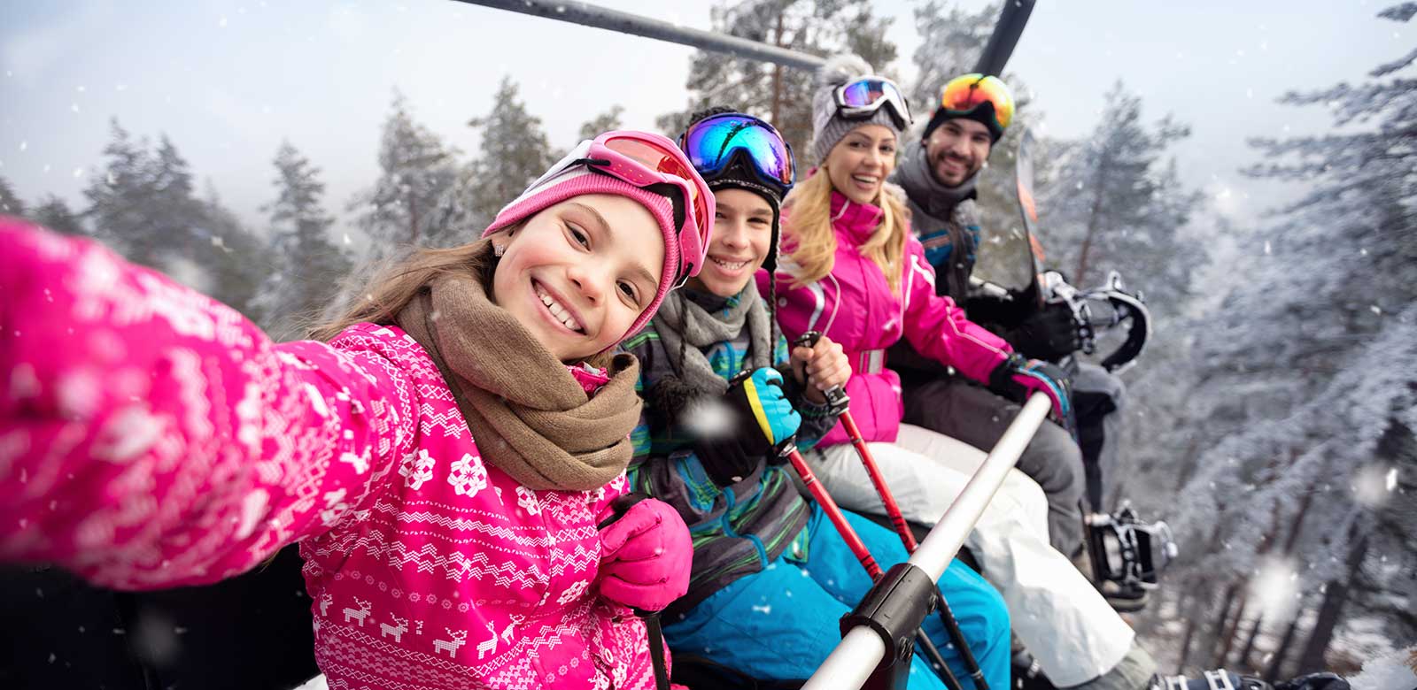 Happy family on the ski chair at our Wolf Creek hotel in Colorado