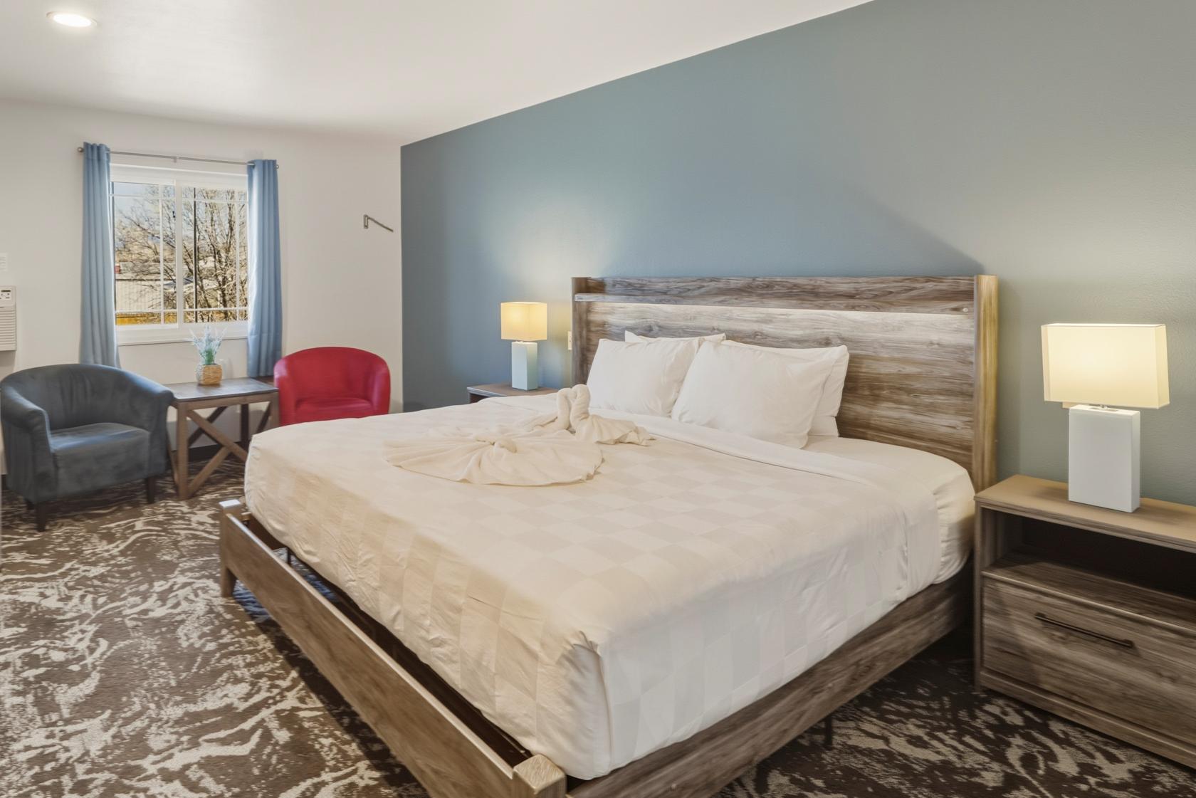 A king size bed in the Mountain View Room at our Pagosa Springs Hotel