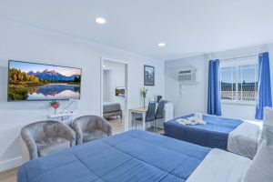 Room with two queen beds, desk and flat screen TV at our hotel in Pagosa Springs.