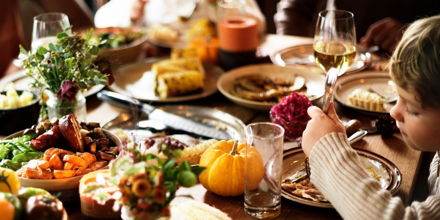A child sitting at the dinner table for Thanksgiving