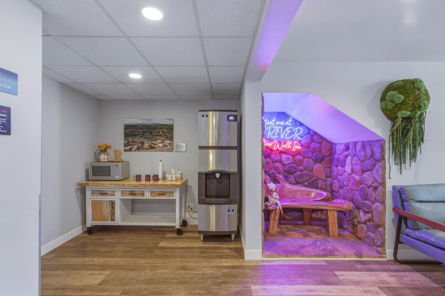 The lobby at our Pagosa Springs lodging with a coffee bar and a seating area under our iconic "Meet me at the River" neon sign.