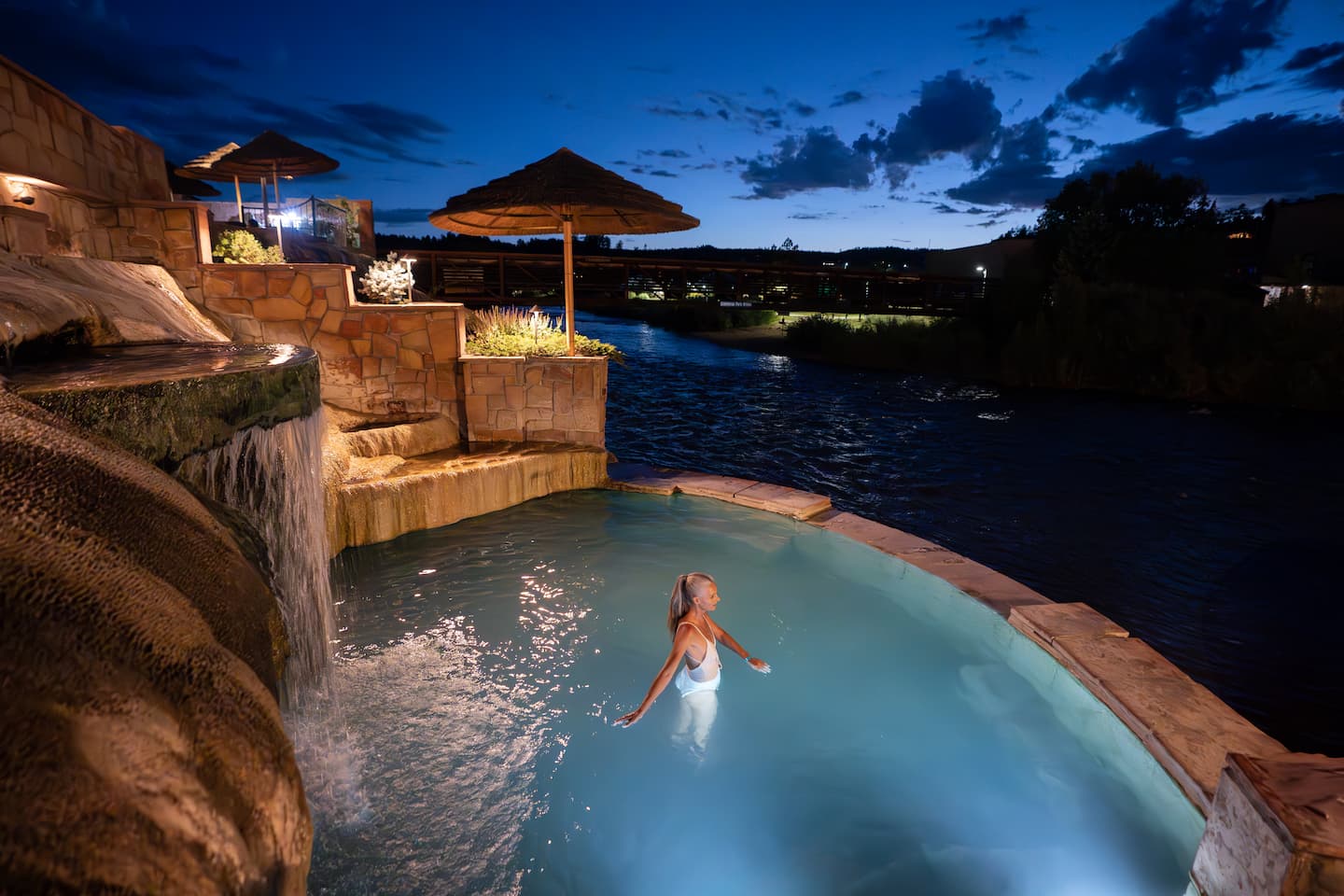 A woman soaking in the Pagosa Springs Hot Springs at night